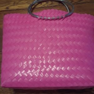 Hot pink plastic tote with chrome handles.